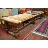 A good large oak refectory dining table, the rectangular top supported on six columns united by