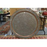 A large Eastern tinned copper circular tray with engraved and pierced decoration.