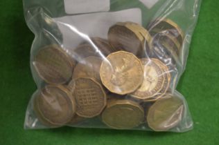 A quantity of Elizabeth II three pence pieces.
