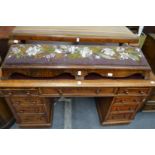 A Victorian walnut fender foot stool with bead work decorated drop-in panel.