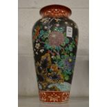 A Chinese famille noire vase.