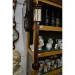 A reproduction mahogany stick barometer by Comitti & Son, London.