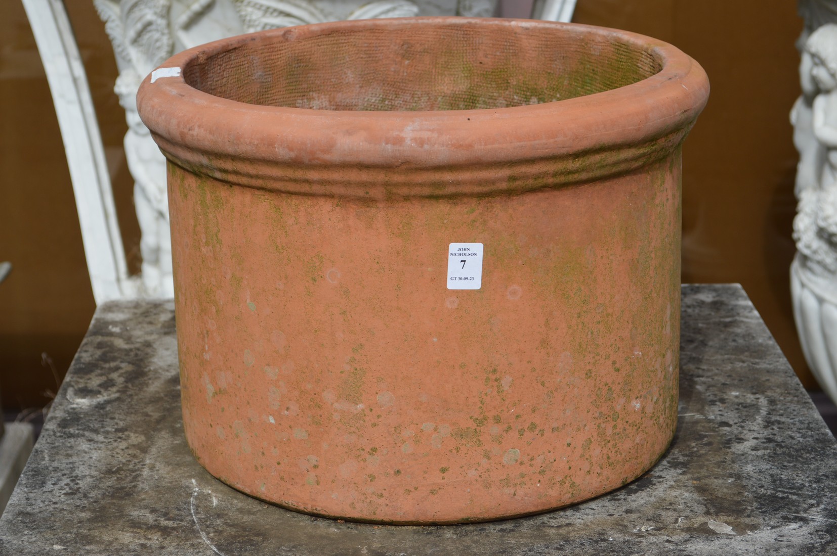 A large terracotta circular plant pot.