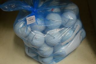 A bag of fifty Taylor Made golf balls.