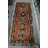 A good Persian small runner or hall carpet, red ground with five large geometric panels, 205cm x