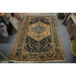 A Persian rug, blue and cream ground with stylised decoration, 195cm x 130cm.