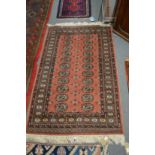 A modern pink ground Bokhara carpet, 153cm x 96cm.