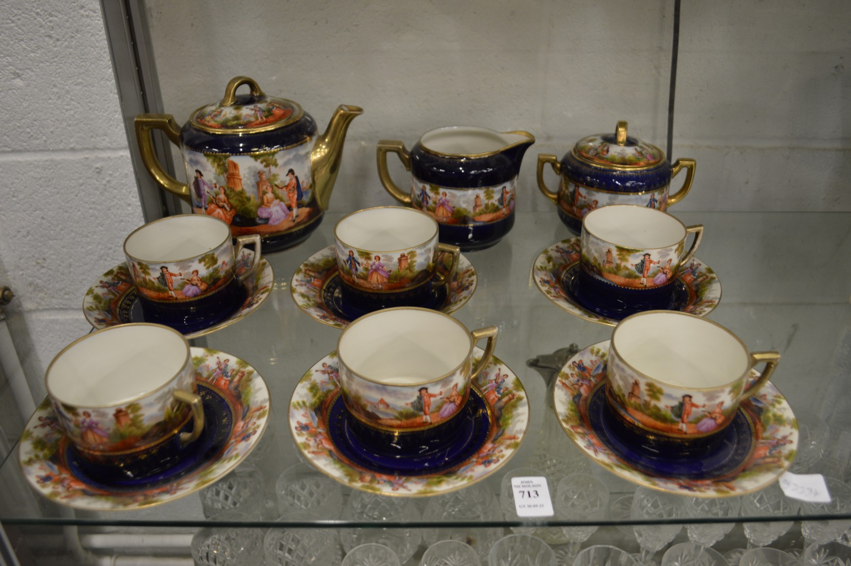 Continental porcelain tea service decorated with figures in a landscape.
