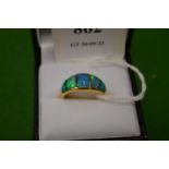 An 18ct gold and opal five stone ring, size M.