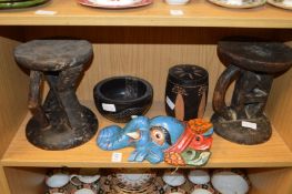 Carved wood African head rests, a colourful painted Indian elephant mask and other items.