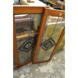 A pair of pine framed cupboards with stained glass leaded panels.