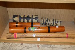 A collection of Aboriginal rain tubes and other musical instruments.