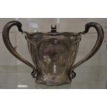 A good art nouveau silver tyg or loving cup with engraved crest.