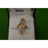 An 18ct gold and multi-coloured gem set crossover ring, size ).