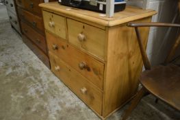 A pine chest of drawers.