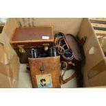 Two pairs of binoculars and a leather box.