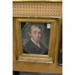 19th century bust length portrait of gentleman in a verre eglomise and giltwood frame.