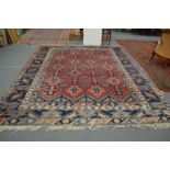 A good large Persian design carpet, red ground with stylised decoration, 375cm x 300cm.