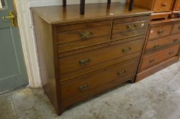 A walnut chest of drawers.
