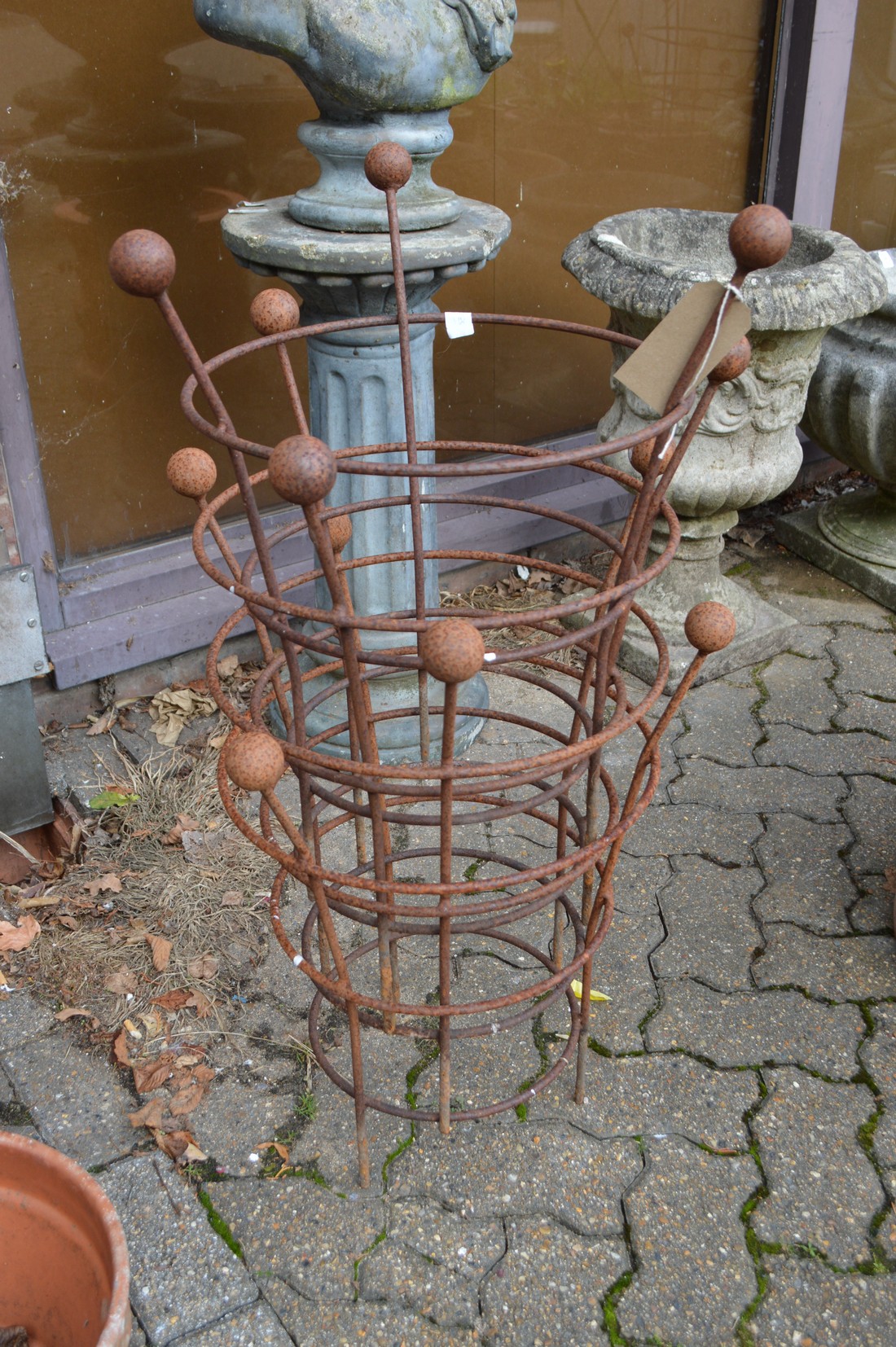 A set of four wrought iron plant climbing frames.