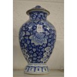 A Chinese blue and white baluster shaped vase and cover.