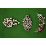 Three decorative brooches.