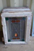Six small framed leaded lights with stained glass decoration.