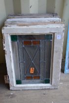 Six small framed leaded lights with stained glass decoration.
