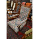 A Victorian walnut framed open armchair.