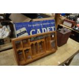 Henry Wintermans cigar display case, a Cadet cigarette sign and a Shell petrol can.