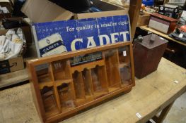 Henry Wintermans cigar display case, a Cadet cigarette sign and a Shell petrol can.