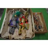 A pair of unusual puppets and a collection of Chinese figures.