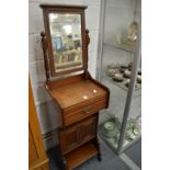 A late Victorian walnut wash stand with mirror.