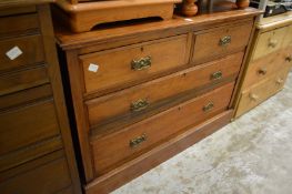 A walnut chest of drawers.