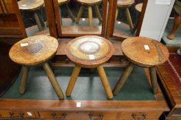 A set of three unusual Welsh stools with tooled leather tops.