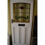 A painted external door with leaded and stained glass panel.