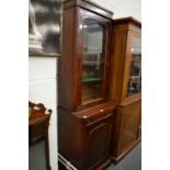 A Victorian mahogany narrow cupboard bookcase.