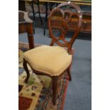 A set of four walnut framed dining chairs on cabriole legs.