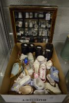 A collection of porcelain shoes, thimbles and other items.