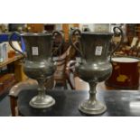 A pair of pewter loving cups.