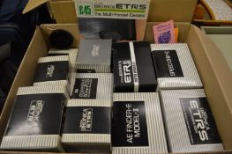 A large quantity of Bronica camera equipment to include an ETRS body and numerous accessories, all