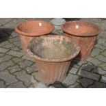 A pair of terracotta plant pots and a similar pot.