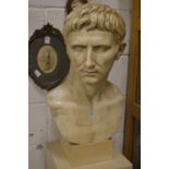 A large Roman style plaster bust of a man.