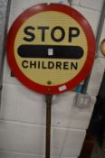 An old 'Stop Children' lollipop sign.