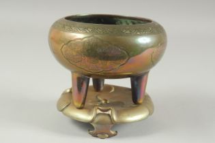 A CHINESE ENGRAVED BRASS TRIPOD CENSER AND FITTED BRASS STAND.