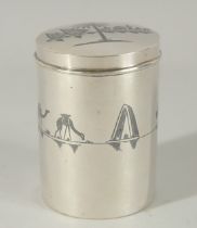 A FINE IRAQI NIELLO INLAID SILVER CYLINDRICAL BOX; possibly a tea caddy, 9cm high.