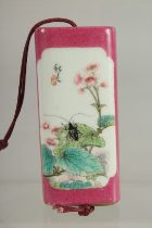 AN UNUSUAL CHINESE FAMILLE ROSE PORCELAIN INRO, the inner case painted with erotic scenes, 9cm