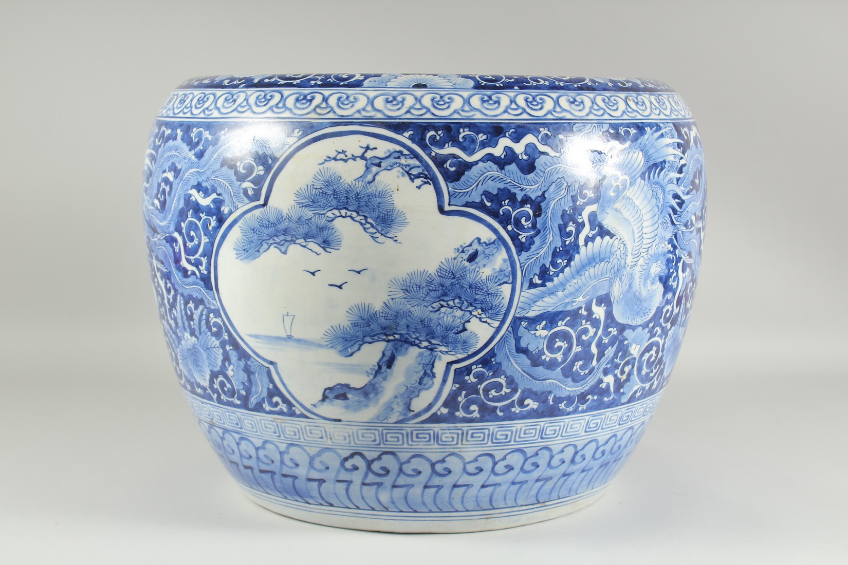 A LARGE BLUE AND WHITE PORCELAIN JARDINIERE, painted with phoenix and panels of flora, (af), 45cm - Image 2 of 5