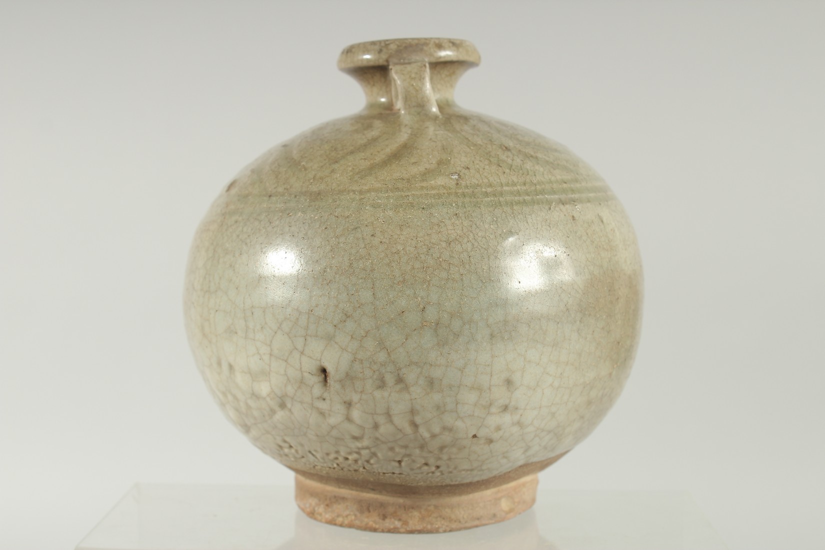 A CELADON GLAZED POTTERY TWIN HANDLE BOTTLE / VASE, with carved decoration to the shoulder, 16cm - Image 2 of 6