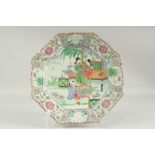 A CHINESE FAMILLE ROSE PORCELAIN OCTAGONAL PLATE, painted with two female figures and a child in